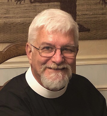 portrait of Father David Monroe in clerical collar