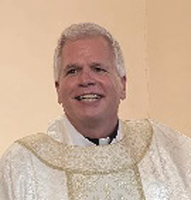 Portrait of Father Michael Ellis in white vestements