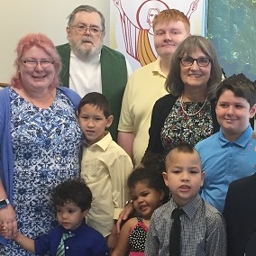 Fr Joe surrounded by parishioners after baptism 2